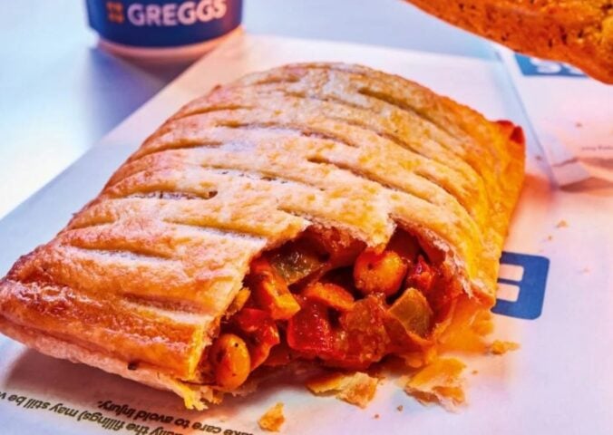 Photo shows the returning Greggs Spicy Vegetable Curry Bake alongside a cup of a coffee