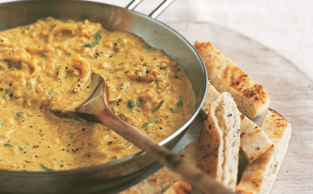 an example of high protein vegan recipes to make for Veganuary, a pan of coconut dhal with toasted naan fingers on the side