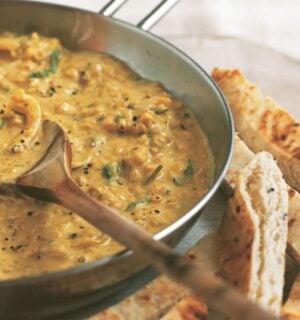 an example of high protein vegan recipes to make for Veganuary, a pan of coconut dhal with toasted naan fingers on the side