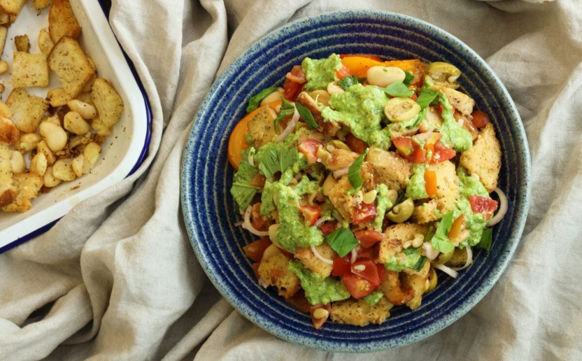 a picture of a panzanella pasta salad with croutons, tomato, onion, and plant-based feta for Veganuary lunch ideas