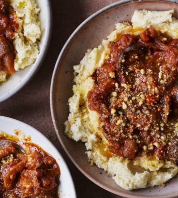 three bowls of vegan pulled aubergine ragu on top of hummus infused mash