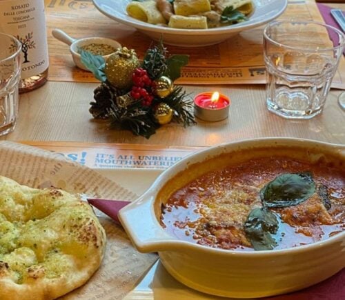 Photo shows several dishes from the vegan Italian restaurant Sora Lella on a table