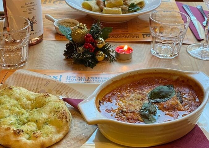 Photo shows several dishes from the vegan Italian restaurant Sora Lella on a table