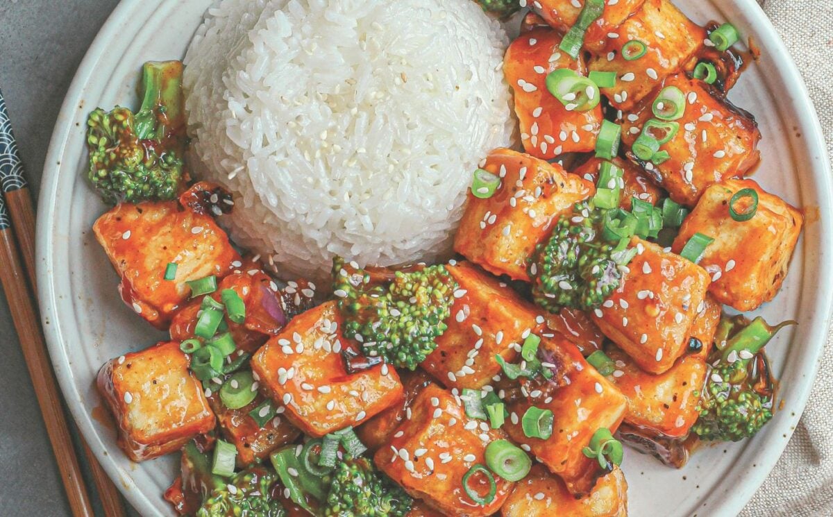 a plate of rice and spicy sweet & sour tofu broccoli stir fry