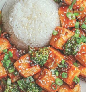 a plate of rice and spicy sweet & sour tofu broccoli stir fry