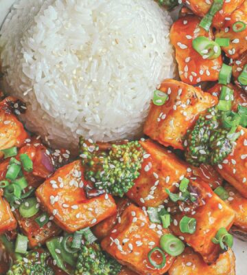 a plate of rice and spicy sweet & sour tofu broccoli stir fry