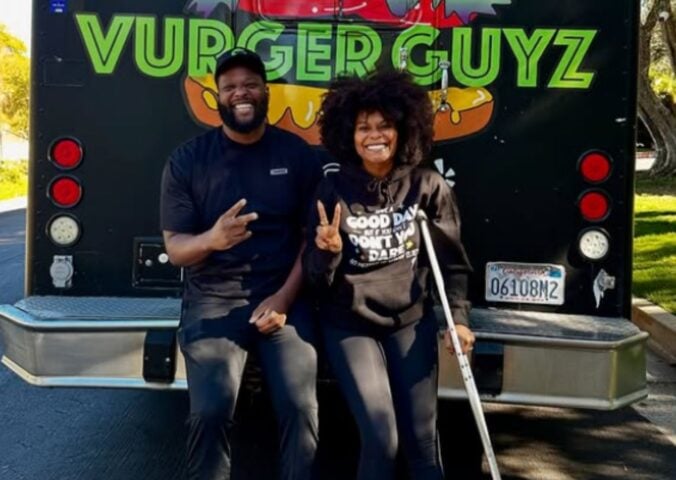 Photo shows Tabitha Brown and Vurger Guyz founder Na’eem Outler sat on the back of the Vurger Guyz food truck