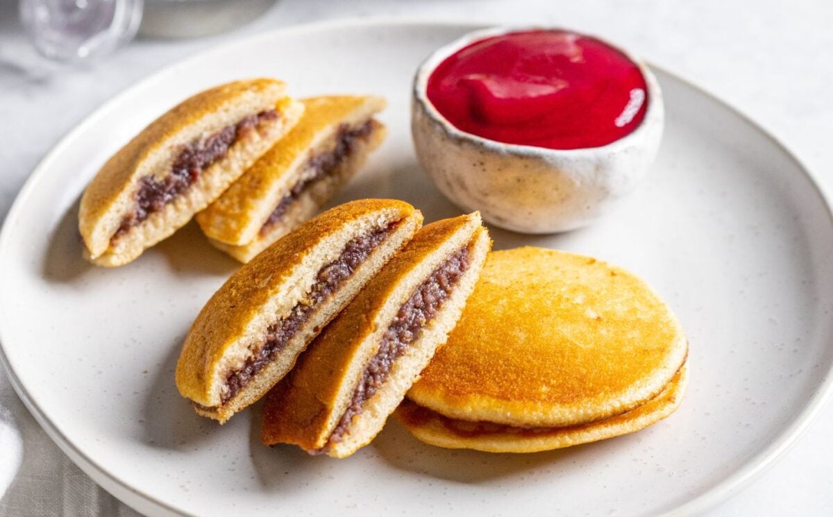 a plate of vegan dorayaki pancakes with raspberry sauce