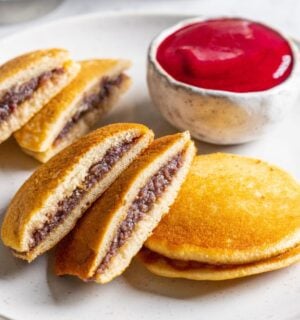 a plate of vegan dorayaki pancakes with raspberry sauce