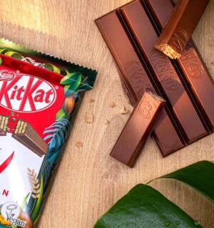 A vegan KitKat in its packaging next to the wafter bars