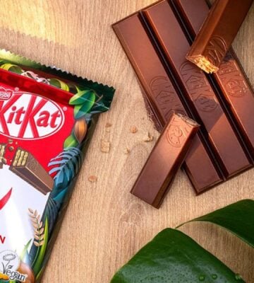 A vegan KitKat in its packaging next to the wafter bars