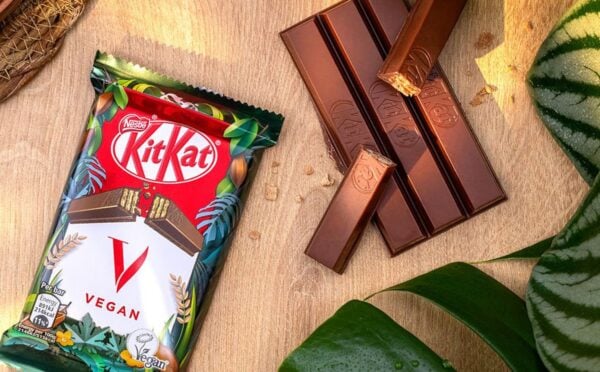 A vegan KitKat in its packaging next to the wafter bars