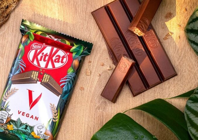 A vegan KitKat in its packaging next to the wafter bars