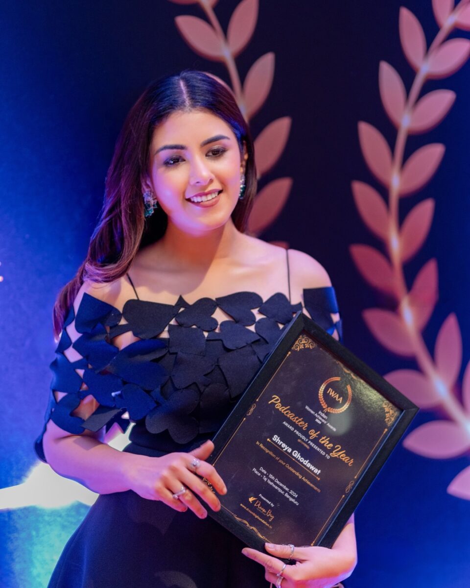 Vegan campaigner Shreya Ghodowat holding her Podcast of the Year award