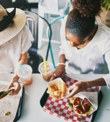 Two women eating vegan food in a vegan restaurant