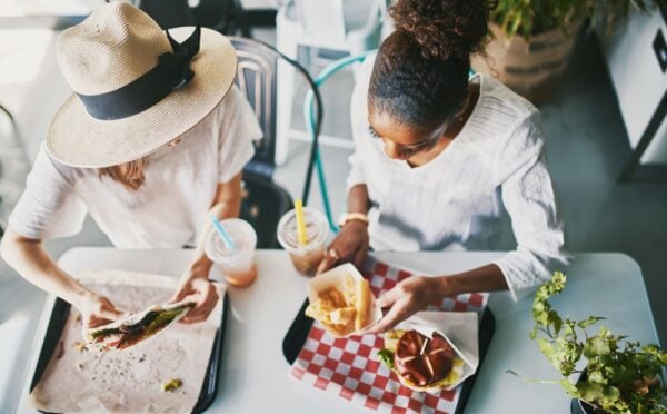 Two women eating vegan food in a vegan restaurant