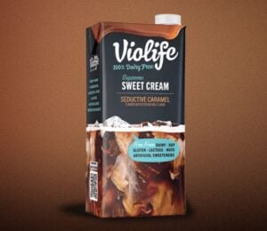 A carton of Violife lentil coffee creamer in front of a brown background