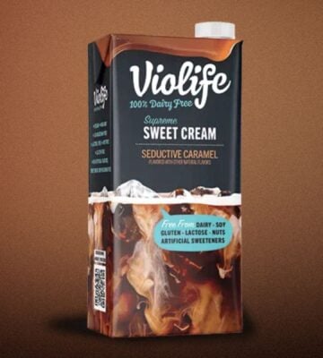 A carton of Violife lentil coffee creamer in front of a brown background