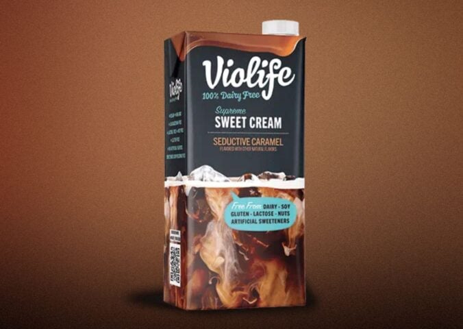 A carton of Violife lentil coffee creamer in front of a brown background