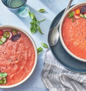 two bowls of watermelon gazpacho made with watermelon, tomato, cucumber, and herbs
