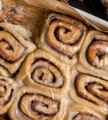 a baking dish full of vegan chai spiced cinnamon rolls