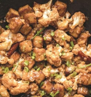 a wok full of vegan chili cauliflower and tofu