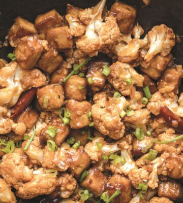 a wok full of vegan chili cauliflower and tofu