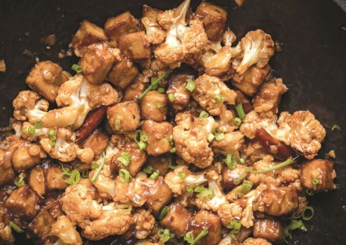 a wok full of vegan chili cauliflower and tofu