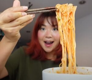 Rose Lee, who runs Cheap Lazy Vegan, eating noodles