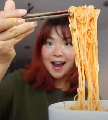 Rose Lee, who runs Cheap Lazy Vegan, eating noodles