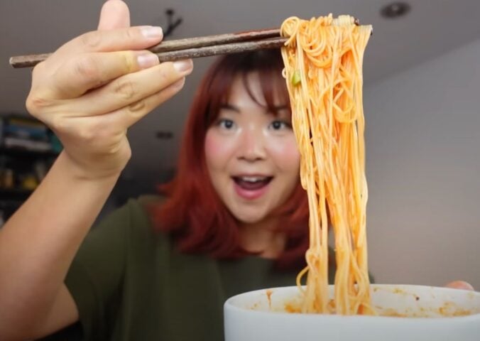 Rose Lee, who runs Cheap Lazy Vegan, eating noodles