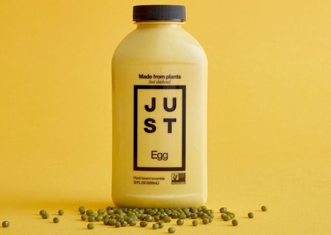 A bottle of Just Egg in front of a yellow background, a plant-based egg alternative