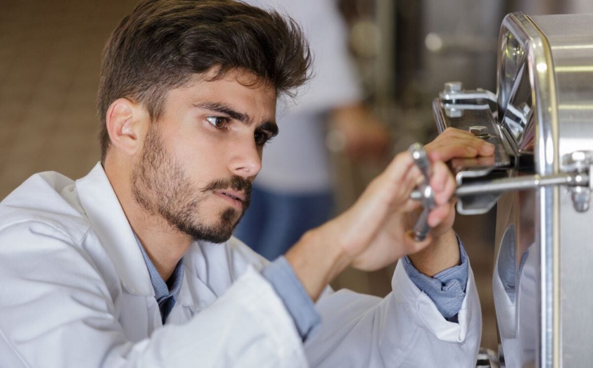 man fixing a fermentation vat