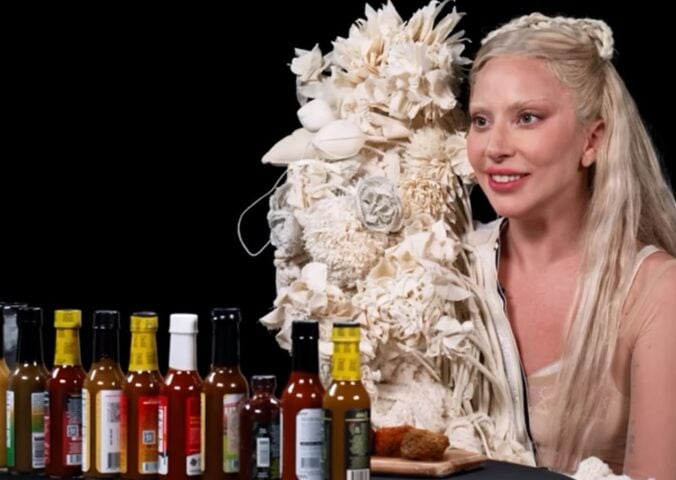 Photo shows Lady Gaga appearing on the YouTube show Hot Ones, where she ate vegan chicken wings