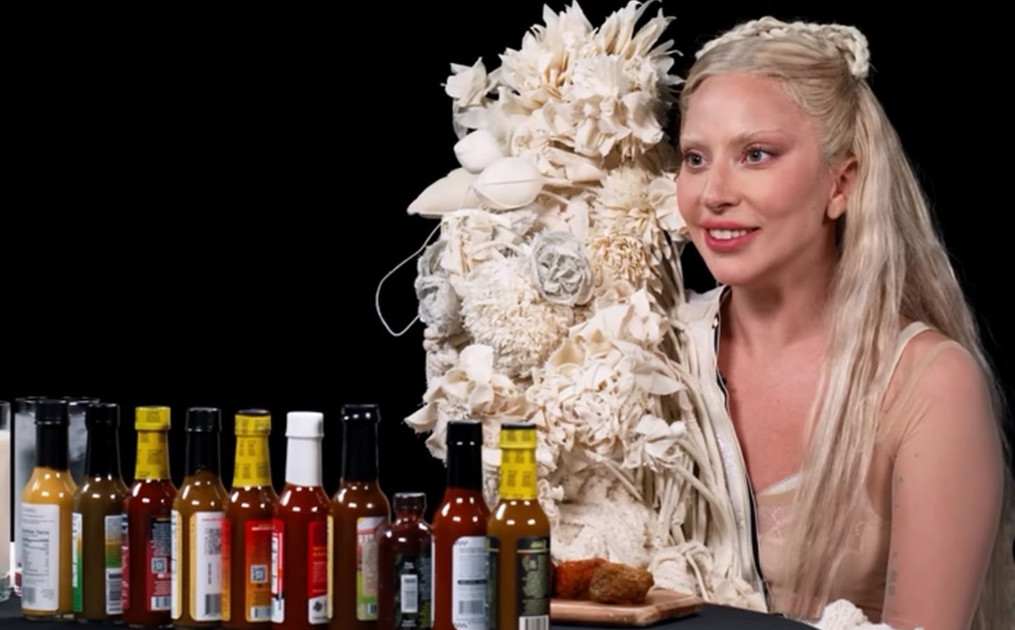 Photo shows Lady Gaga appearing on the YouTube show Hot Ones, where she ate vegan chicken wings