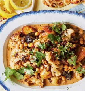 a dish of oven-baked butter chickpeas with chutney, cauliflower, potatoes, and curry spices