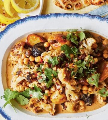 a dish of oven-baked butter chickpeas with chutney, cauliflower, potatoes, and curry spices