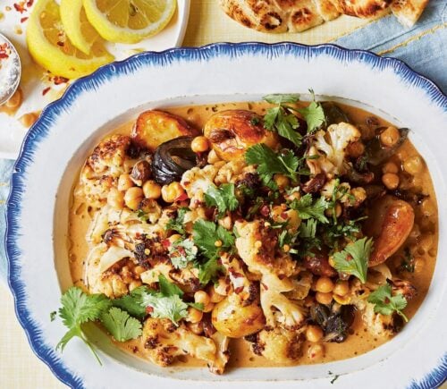 a dish of oven-baked butter chickpeas with chutney, cauliflower, potatoes, and curry spices