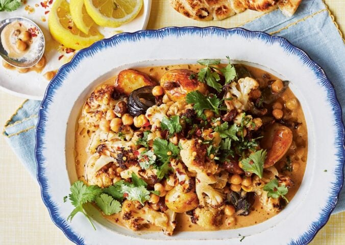 a dish of oven-baked butter chickpeas with chutney, cauliflower, potatoes, and curry spices