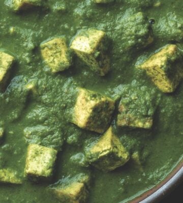 a bowl of Pālak tofu with spinach gravy with turmeric tofu