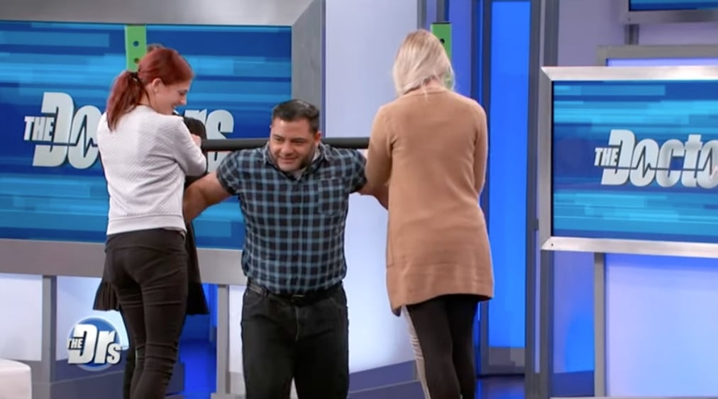 Patrik Baboumian carrying four women during an appearance on US TV show "The Doctors"