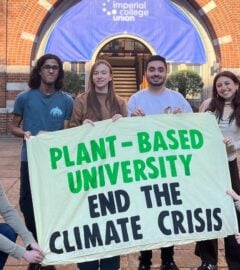 Students at Imperial College London holding up a sign saying "Plant-Based University End The Climate Crisis"