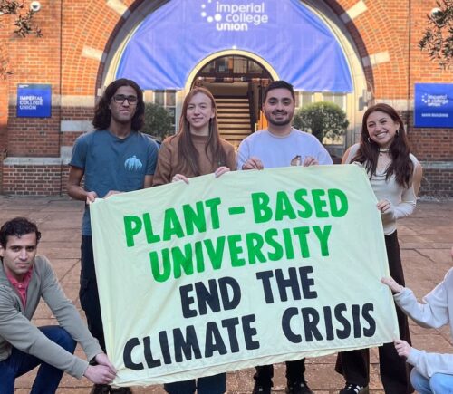 Students at Imperial College London holding up a sign saying "Plant-Based University End The Climate Crisis"