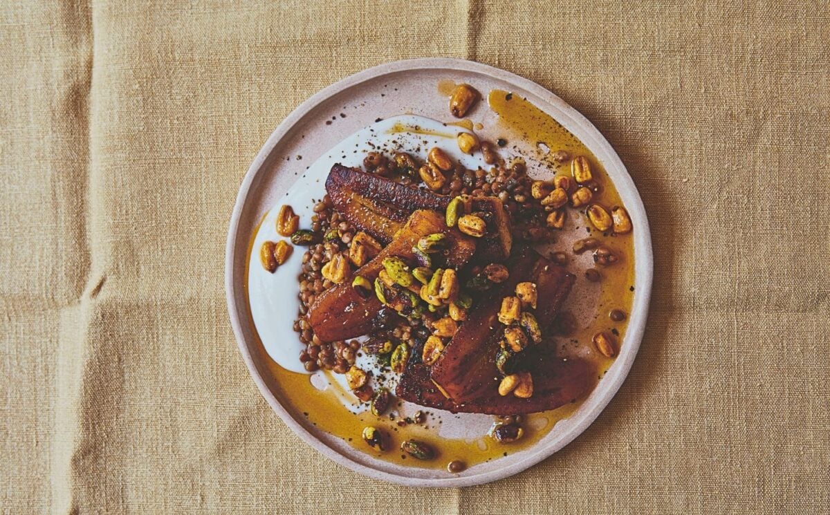 a plate of plantain and brown lentils with hot pistachio and corn nut dressing