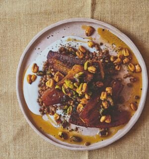 a plate of plantain and brown lentils with hot pistachio and corn nut dressing