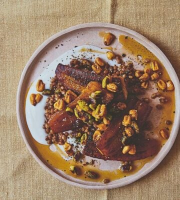 a plate of plantain and brown lentils with hot pistachio and corn nut dressing