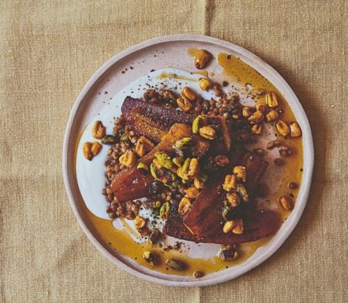 a plate of plantain and brown lentils with hot pistachio and corn nut dressing