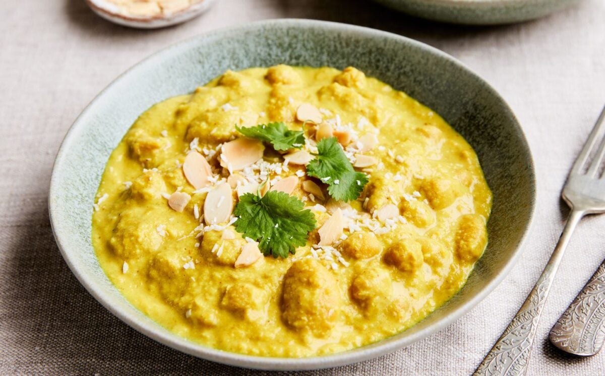 rainy day vegan dinner ideas. chickpeas and cannellini beans cooked in a coconut milk, carrot, and almond sauce