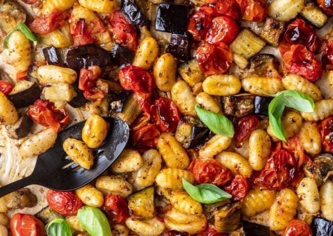 a sheet pan gnocchi alla norma with eggplant. basil, tomato, and gnocchi