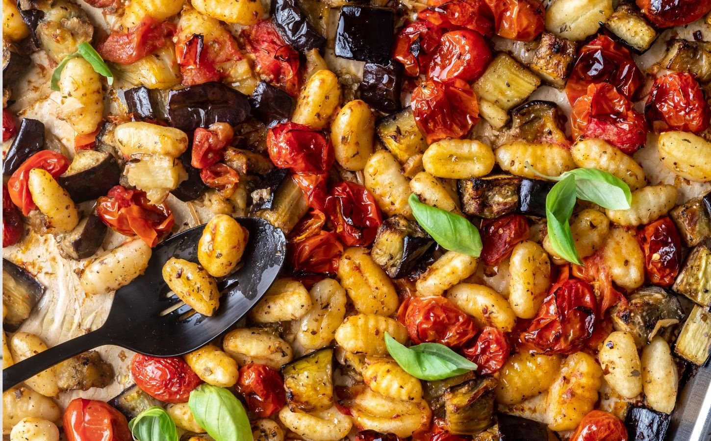 a sheet pan gnocchi alla norma with eggplant. basil, tomato, and gnocchi